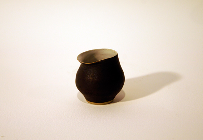 Small matt black jug with white interior Rie