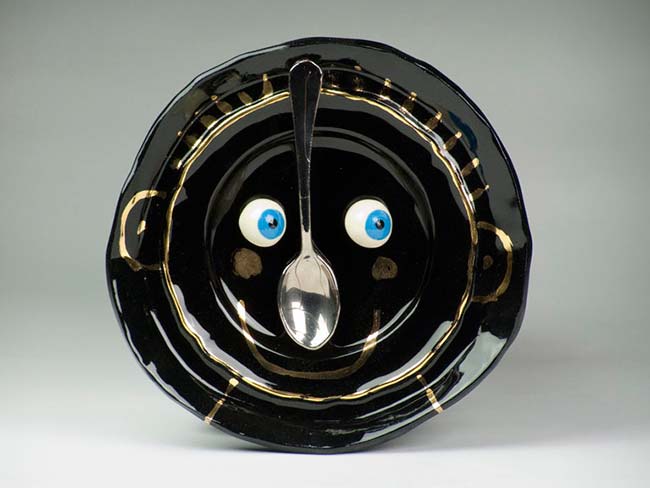 Black plate with smile and spoon Bird